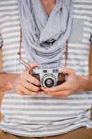 Man standing with a camera