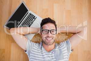 Man lying on the floor with laptop