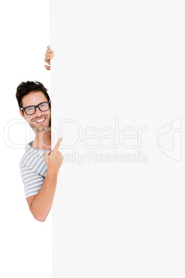 Man in spectacles hiding behind the white board