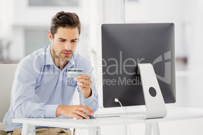 Businessman doing online shopping on computer