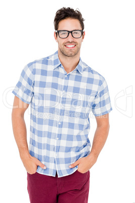 Handsome man is spectacles standing with hands in pockets