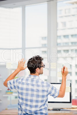 Rear view of man writing on sticky notes