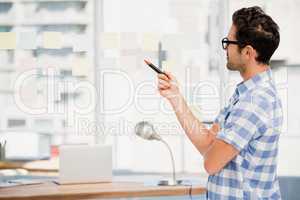 Thoughtful man reading at sticky notes on window