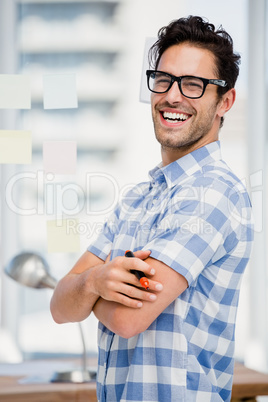 Portrait of man standing with marker in office