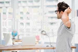 Thoughtful man looking at sticky notes on window