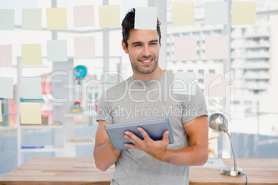 Man holding digital tablet and sticky notes