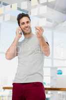 Man looking at a sticky notes while talking on phone