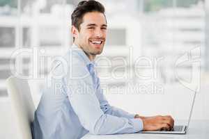 Portrait of businessman working on computer