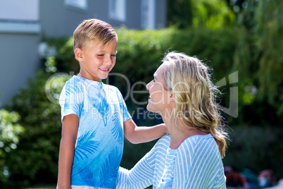 Smiling mother with son at backyard