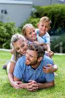 Happy family enjoying on grass in yard