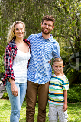 Portrait of happy family standing at yard