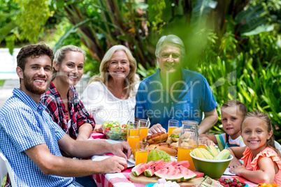 Happy family having lunch in yard