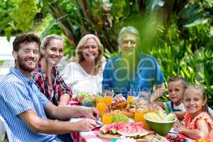 Happy family having lunch in yard