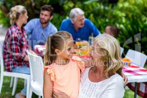 Granny carrying granddaughter at yard