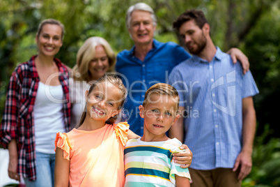 Multi-generation family standing in yard