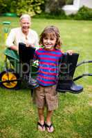 Boy with wellington boots while standing in yard