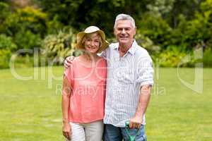 Senior couple standing at yard