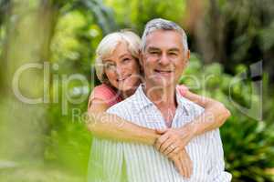 Smiling couple standing in yard