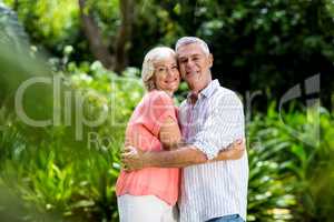 Smiling senior couple embracing at yard