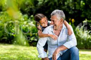 Grandfather and grandaughter playing at yard