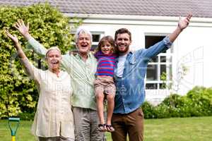 Father and son with grandparents stanidng  at yard