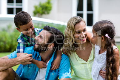 Close-up of family sitting in yard