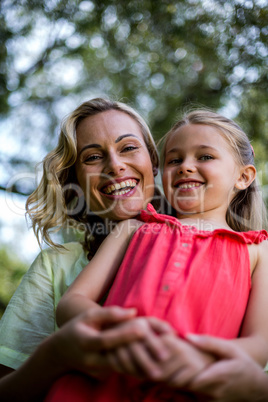 Smiling mother with daughter in yard