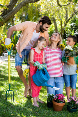 Parents with children gardening in yard