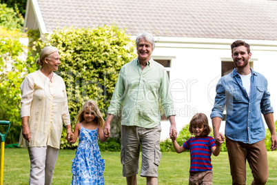 Happy family walking outside house at yard