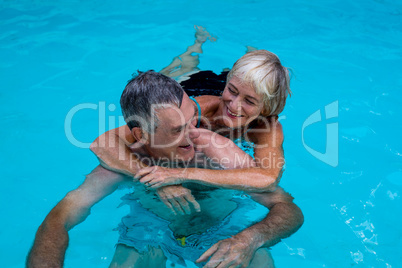 Happy senior couple in swimming pool