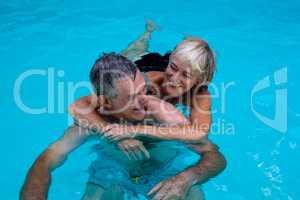 Happy senior couple in swimming pool