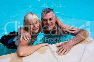 Senior couple swimming in pool