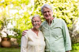 Smiling senior couple in yard