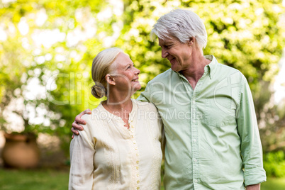 Couple looking each other while standing in yard