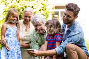 Smiling father taking selfie with family