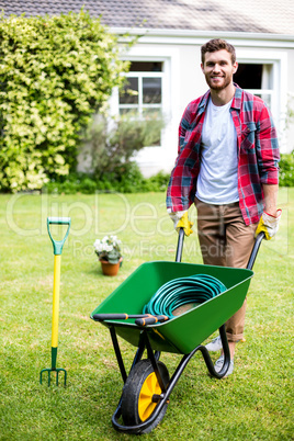 Man holding rake in yard