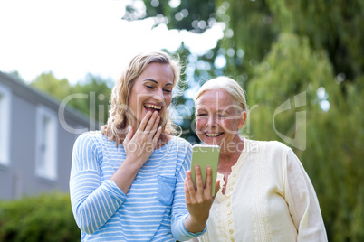 Granddaughter showing phone to grandmother