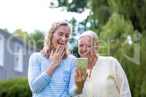 Granddaughter showing phone to grandmother