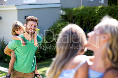 Happy parents carrying children