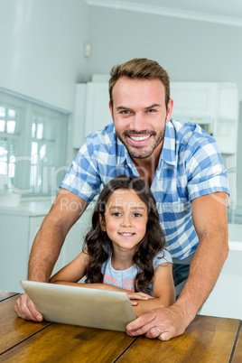 Father and daughter using digital tablet at home Father and daughter using digital tablet at home