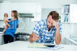 Tensed father calculating home finance