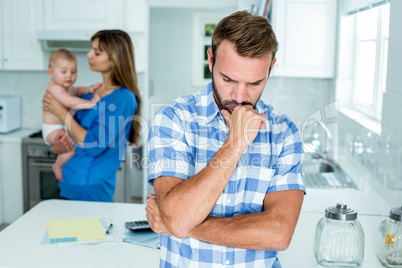 Upset man with family in kitchen