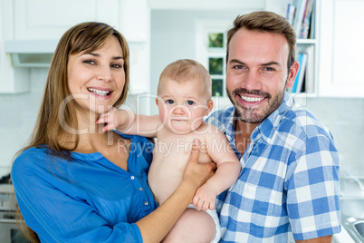 Happy parents with baby boy at home
