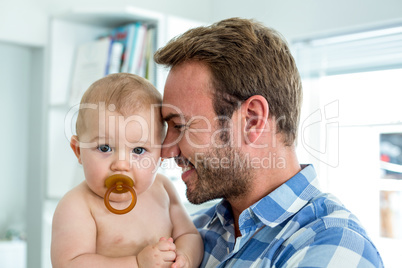 Happy father with cute son at home