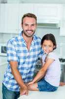 Happy father and daughter in kitchen at home