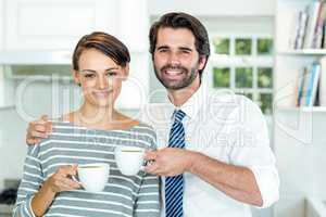 Happy couple drinking coffee at home