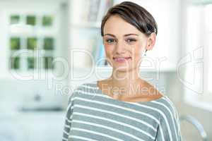 Portrait of beautiful woman standing in kitchen