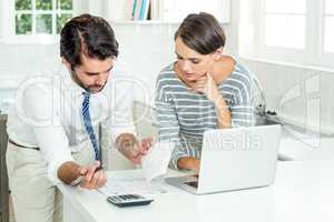 Businessman with woman looking at document