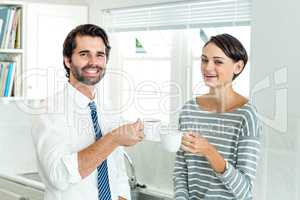 Portrait of businessman with woman enjoying coffee