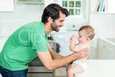 Father with son drinking milk at kitchen table